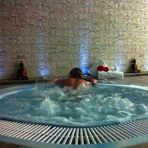 En el tranquilo jacuzzi, abrazado por paredes de piedra, alguien se relaja entre lujosas toallas y elegantes estatuas: un comienzo perfecto antes de descubrir el Palacio de Granada o disfrutar de un refrescante Circuito en Spa + masaje. - ForTwo - Planes para parejas