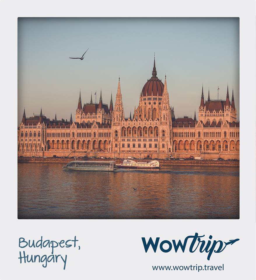 El Parlamento húngaro junto al río Danubio al atardecer, Budapest, un lugar impresionante con un pájaro en el cielo. Disfrute de esta vista con nuestro "Viaje sorpresa con vuelo y hotel a una ciudad de Europa". - ForTwo - Planes para parejas