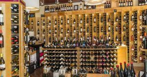 En el corazón de Barcelona, Di-Ví exhibe una vibrante colección de vinos y vermuts, creando una exhibición colorida que recuerda a una escena de aperitivo. - ForTwo - Planes para parejas