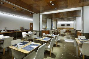 El Hotel Eurostars Gran Valencia le recibe con un moderno restaurante con mesas cuidadosamente dispuestas, techo de madera y suelo de baldosas brillantes. - ForTwo - Planes para parejas