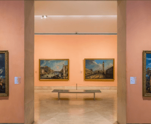 La sala de la galería de arte, que recuerda a las Entradas para Brunch y Arte en el Museo Thyssen, cuenta con paredes rosas adornadas con tres grandes pinturas enmarcadas, completas con un banco central para una apreciación reflexiva. - ForTwo - Planes para parejas