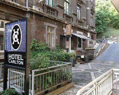 El paquete Budapest en pareja ofrece una estadía romántica en el Carlton Hotel, que exhibe una encantadora fachada de ladrillo, frondosos árboles y un pintoresco camino adoquinado ideal para paseos en días soleados. - ForTwo - Planes para parejas