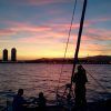 Disfruta de un perfecto "Paseo romántico en Catamarán Barcelona" con siluetas al atardecer contra un cielo vibrante y el impresionante skyline de Barcelona. - ForTwo - Planes para parejas