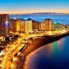 Perspectiva aérea del animado Puerto de la Cruz al atardecer, destacando sus imponentes estructuras y la serena costa del océano. Vívelo con la "Escapada al Puerto de la Cruz con pensión completa con hasta 1 niño gratis (Tenerife). - ForTwo - Planes para parejas