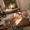 Restaurante Azahar (Sevilla) ofrece una elegante experiencia gastronómica con cristalería, servilletas blancas, manteles individuales tejidos y una linterna de vela, creando el ambiente perfecto de Sevilla. - ForTwo - Planes para parejas