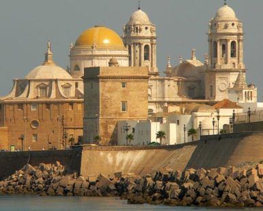 Explora las históricas cúpulas y torres de Cádiz, España, que emergen de la rocosa costa en el "Tour gratuito por Cádiz". Disfruta de una vista inolvidable de este impresionante paisaje urbano desde el agua. - ForTwo - Planes para parejas