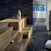 Descubra la tranquilidad de un spa moderno en Serena Spa, Meliá Barcelona Sky. Disfrute de escaleras de madera, faroles, velas, cojines y jarrones altos junto a una mesa pequeña, ideales para relajarse o disfrutar de una experiencia rejuvenecedora con el Desayuno Buffet y el Circuito Spa y Masaje en pareja. - ForTwo - Planes para parejas