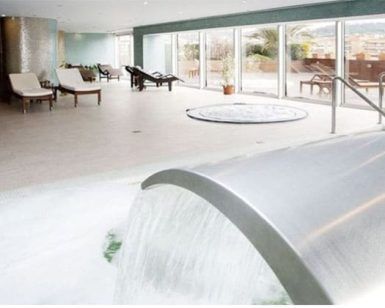 Relájese en el moderno spa con solárium del Barceló Granada Congress, donde las tumbonas junto a una fuente de agua le brindan tranquilidad. Disfrute del ambiente sereno y de las vistas de la ciudad a través de los amplios ventanales en días despejados. - ForTwo - Planes para parejas