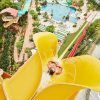 Un emocionante paseo por el gran tobogán acuático amarillo de Caribe Aquatic Park, rodeado de la exuberante vegetación de Port Aventura, crea un día inolvidable en Tarragona con Entradas para el parque acuático Caribe Aquatic Park de Port Aventura (Tarragona). - ForTwo - Planes para parejas