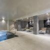 El moderno interior del spa del Hotel Cataluña ofrece una pequeña piscina, tumbonas e iluminación tenue. Los huéspedes podrán relajarse con la experiencia "Circuito de aguas, cava y masaje de esencias para parejas" en Granada. - ForTwo - Planes para parejas