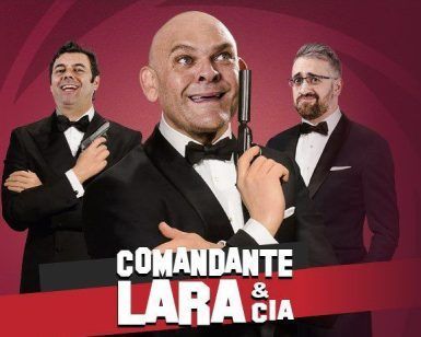 Tres hombres de esmoquin, haciéndose pasar por espías con pistolas de juguete sobre un vibrante fondo rojo, prepararon el escenario para una noche inolvidable en Madrid. El texto dice: Comandante Lara & Cía - Sala Capitol (Madrid). - ForTwo - Planes para parejas