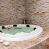 Disfrute de la Sesión de jacuzzi con masaje en Centro Natura (Toledo), donde los pétalos de rosa flotantes realzan el ambiente sereno en medio de un entorno elegantemente embaldosado. - ForTwo - Planes para parejas