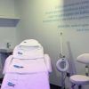 Una sala clínica con sillón de tratamiento, equipamiento y una cita en la pared ofrece serenidad en Valencia con el relajante "Masaje relajante corporal de 50 minutos (Valencia)" de 50 minutos diseñado especialmente para ti. - ForTwo - Planes para parejas