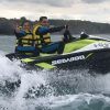 Dos personas, ataviadas con chalecos salvavidas amarillos, disfrutan de un emocionante paseo sobre las olas del océano cerca de los acantilados rocosos de Gijón con Excursión motos de agua (Gijón). - ForTwo - Planes para parejas