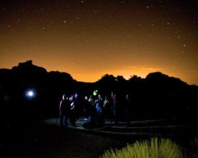 Un grupo disfruta de la Observación astronómica con telescopio de las estrellas (Tenerife) bajo el cielo desértico, lleno de estrellas que proyectan un brillo mágico contra el horizonte anaranjado. - ForTwo - Planes para parejas