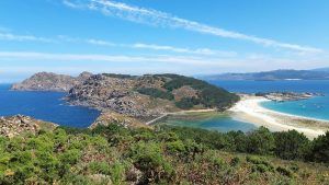 Experimente el pintoresco paisaje costero cerca de Vigo en el "Paseo en barco a las Islas Cíes", donde las colinas rocosas se encuentran con el mar azul, las playas de arena bordean las costas y la vegetación verde vibrante prospera bajo cielos despejados. - ForTwo - Planes para parejas