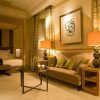 Escápese al elegante Hotel Villa Oniria—Granada, que ofrece una lujosa cama doble, un cómodo sofá, una mesa de centro de cristal con velas y paredes decoradas con obras de arte. Perfecto para el romance o la serenidad en su exquisito spa con nuestra "Escapada romántica con spa en el hotel Villa Oniria 4 estrellas". - ForTwo - Planes para parejas