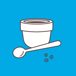 Un mortero con granos de café sobre fondo azul simboliza la esencia del "Taller de Cata de Café en Familia Osorio: ¡Conviértete en un Experto del Café!. - ForTwo - Planes para parejas