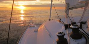 Experimenta Puesta de Sol en Catamarán en Ibiza: La Mejor Experiencia Todo Incluido, mientras navegas por un mar tranquilo con el cielo dorado y el sol reflejándose maravillosamente en el agua. - ForTwo - Planes para parejas