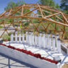 En BIBO PARK Ibiza: Naturaleza y biotecnología, una elegante cúpula de madera abierta con columnas cilíndricas blancas se alza entre vibrantes flores rojas bajo el cielo azul claro. - ForTwo - Planes para parejas