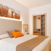 Experimente el acogedor encanto del Hotel Florencio Ibiza en San Antoni. Esta habitación cuenta con una cama doble, tonos neutros, un armario abierto, obras de arte paisajísticas e iluminación cálida, perfecta para sumergirse en la vibrante energía de San Antoni. - ForTwo - Planes para parejas