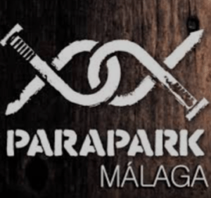 Experimenta el logo de Parapark Málaga con un símbolo de infinito hecho con clavos sobre madera, invitándote a resolver un caso paranormal en la sala de escape inmersiva, "Escape Room: Resuelve un caso paranormal. - ForTwo - Planes para parejas
