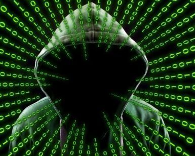 En medio de una cascada de código binario verde sobre fondo negro, la figura encapuchada evoca la intriga del hacking, capturando perfectamente el atractivo siniestro de "🔐 Escape Room Virus y Hackers en Zaragoza. - ForTwo - Planes para parejas