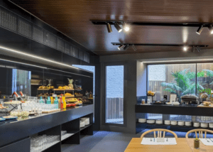 Transforme su comedor en un oasis moderno con el encanto de Barcelona con elegantes buffets, mesas elegantes e iluminación vibrante de la colección B-Heaven Rooftop Barcelona. Una pared de cristal revela vistas verdes al aire libre que evocan una escapada serena. - ForTwo - Planes para parejas